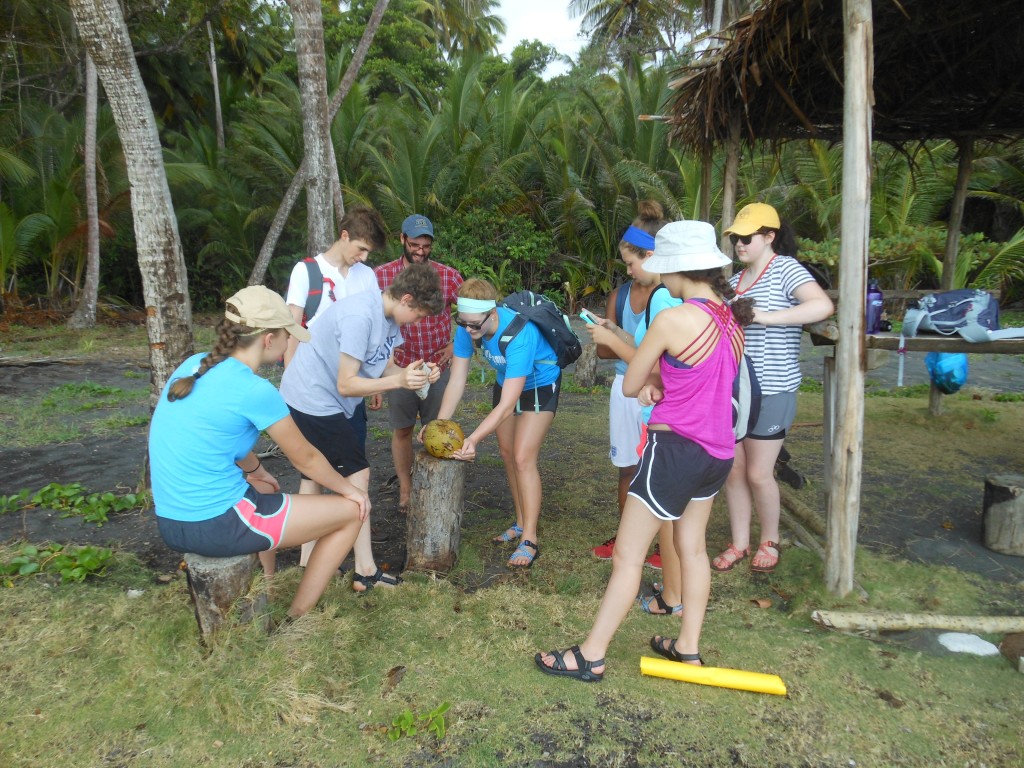 The group breaking open its first coconut!